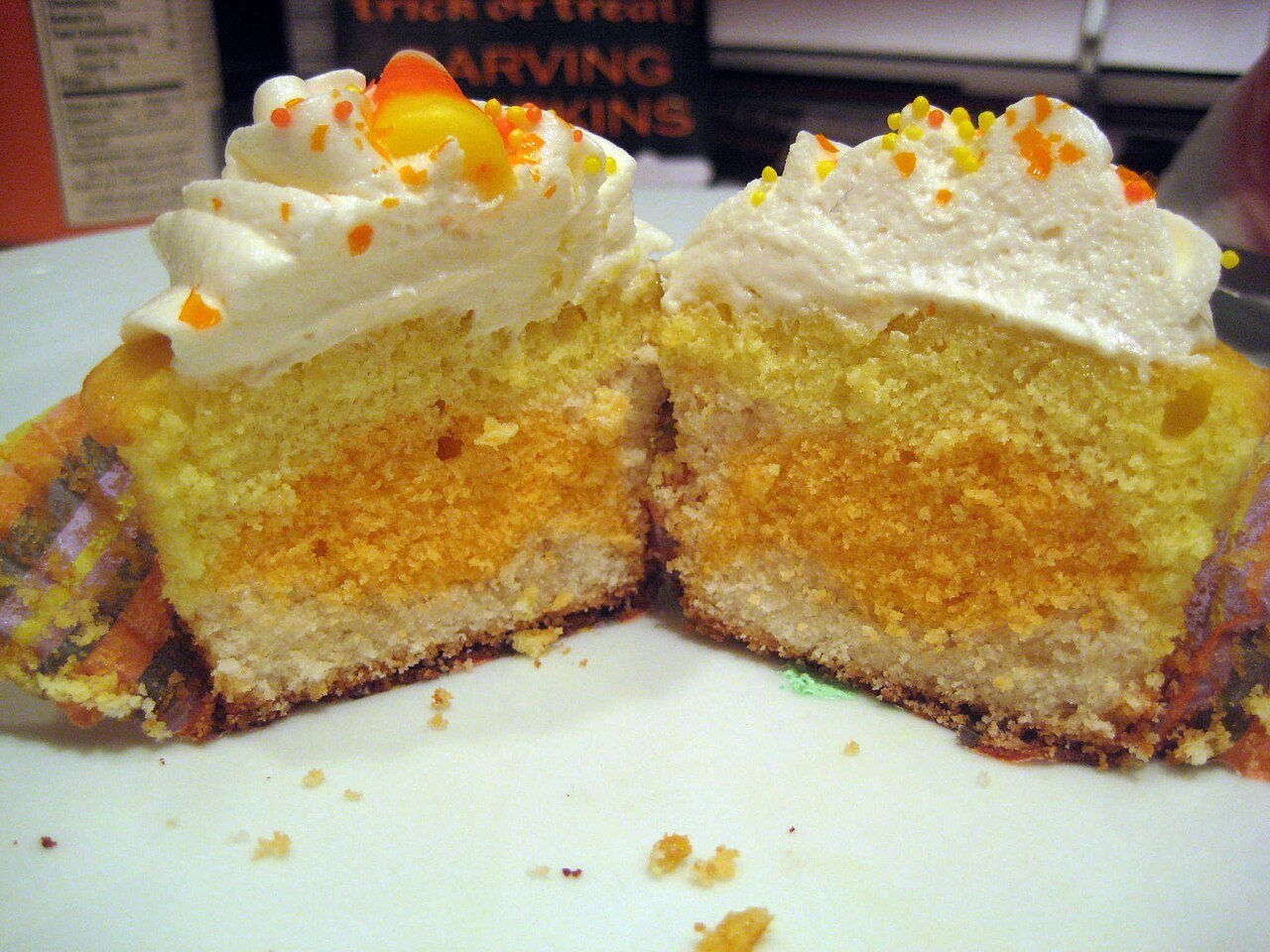 Cut cross-section of a layered vanilla cake with buttercream